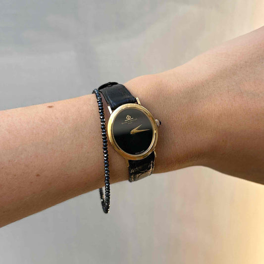 Baume & Mercier Ellipse: 18k Gold Vintage Ladies Watch Black Dial with Blue Sapphire Crown Full Set Near NOS