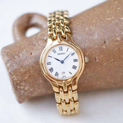 Seiko Vintage Watch: Ladies 80s Golden Blued Hands White Roman Dial