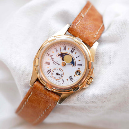 Osco Moon Phase Watch: Ladies 90s Gold with Roman Numerals Blue White Dial