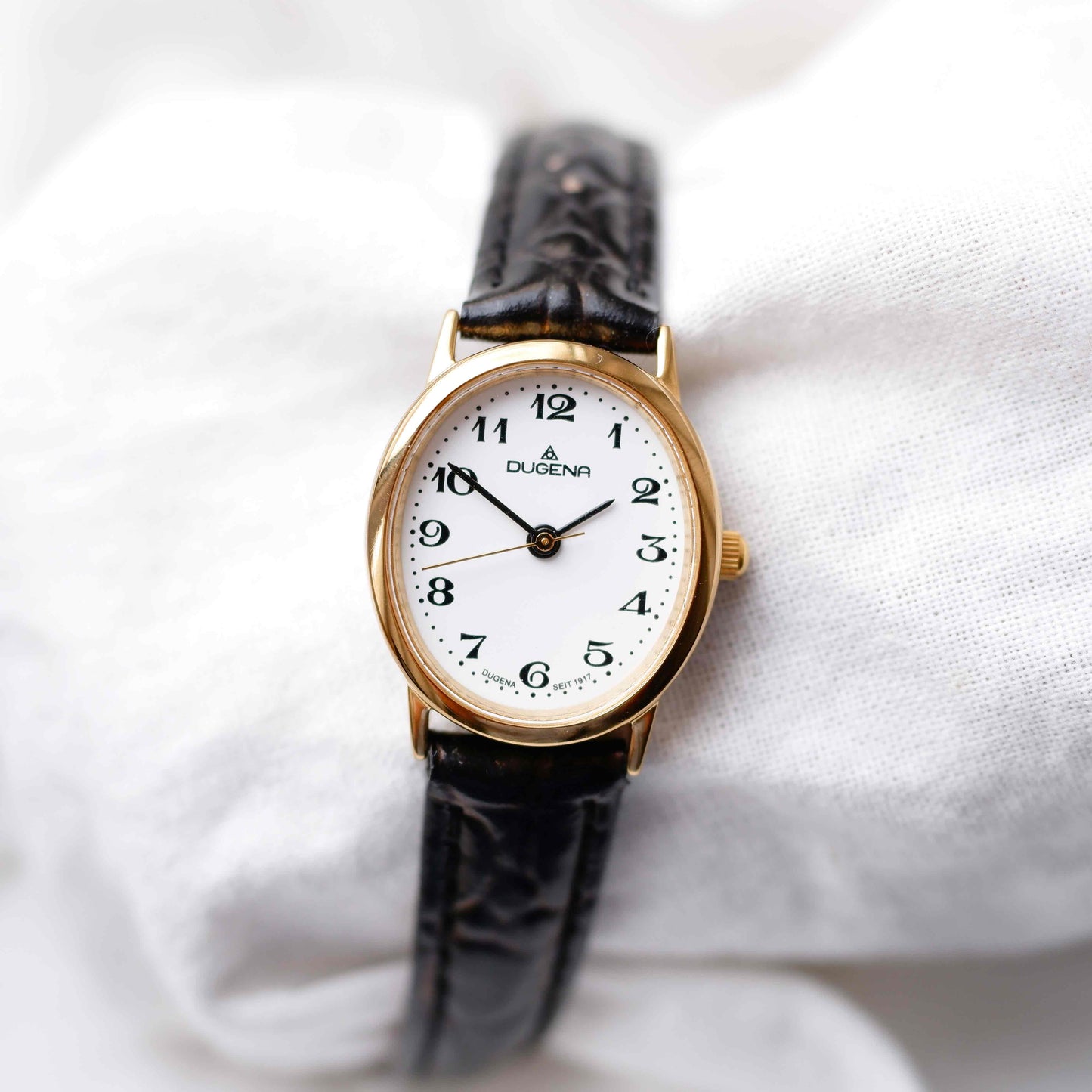 Dugena Oval Watch: Ladies Dainty 90s Gold with White Dial - NOS