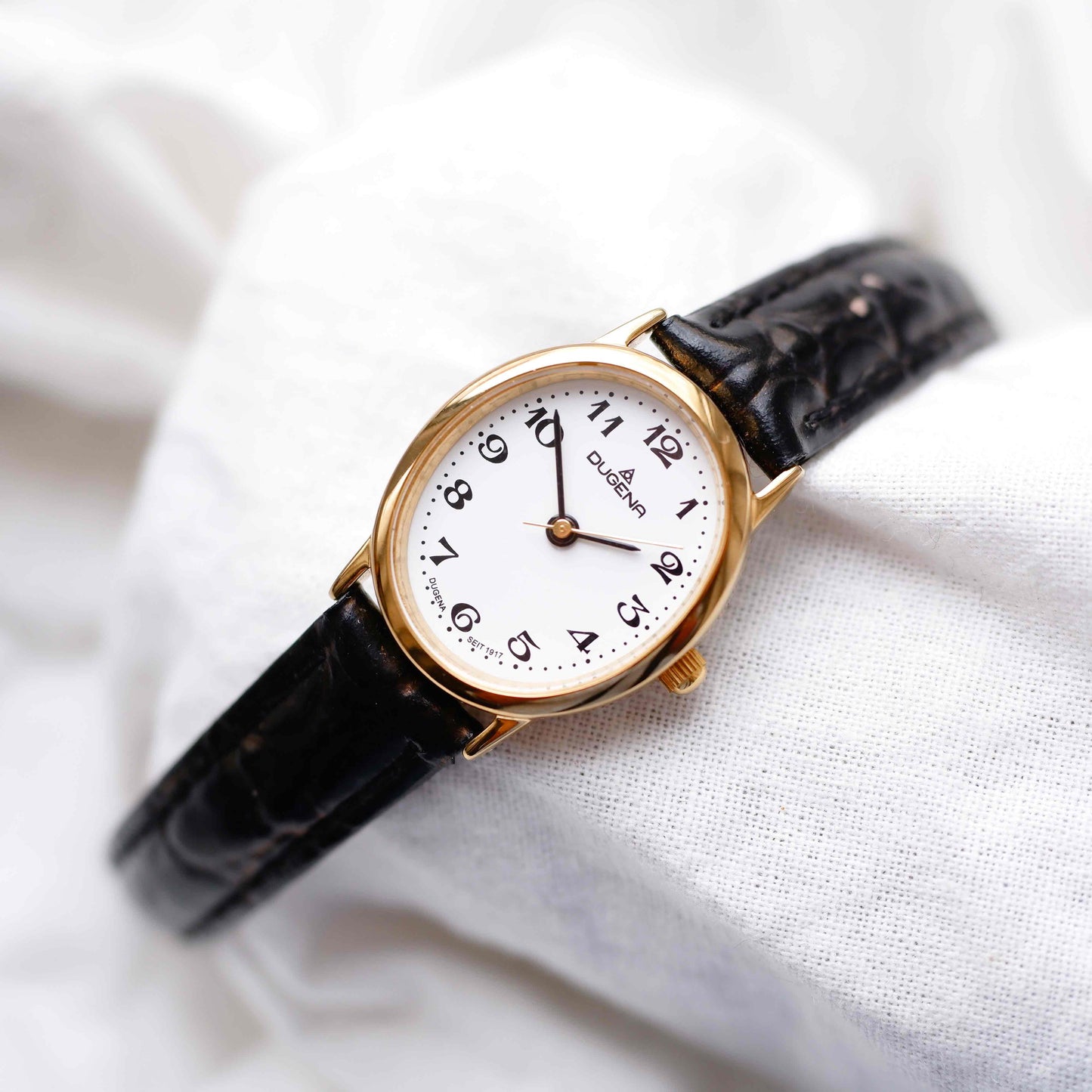 Dugena Oval Watch: Ladies Dainty 90s Gold with White Dial - NOS