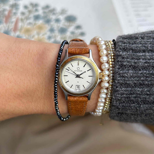 Eterna Vintage Watch: Ladies 80s Gold with White Linen Dial